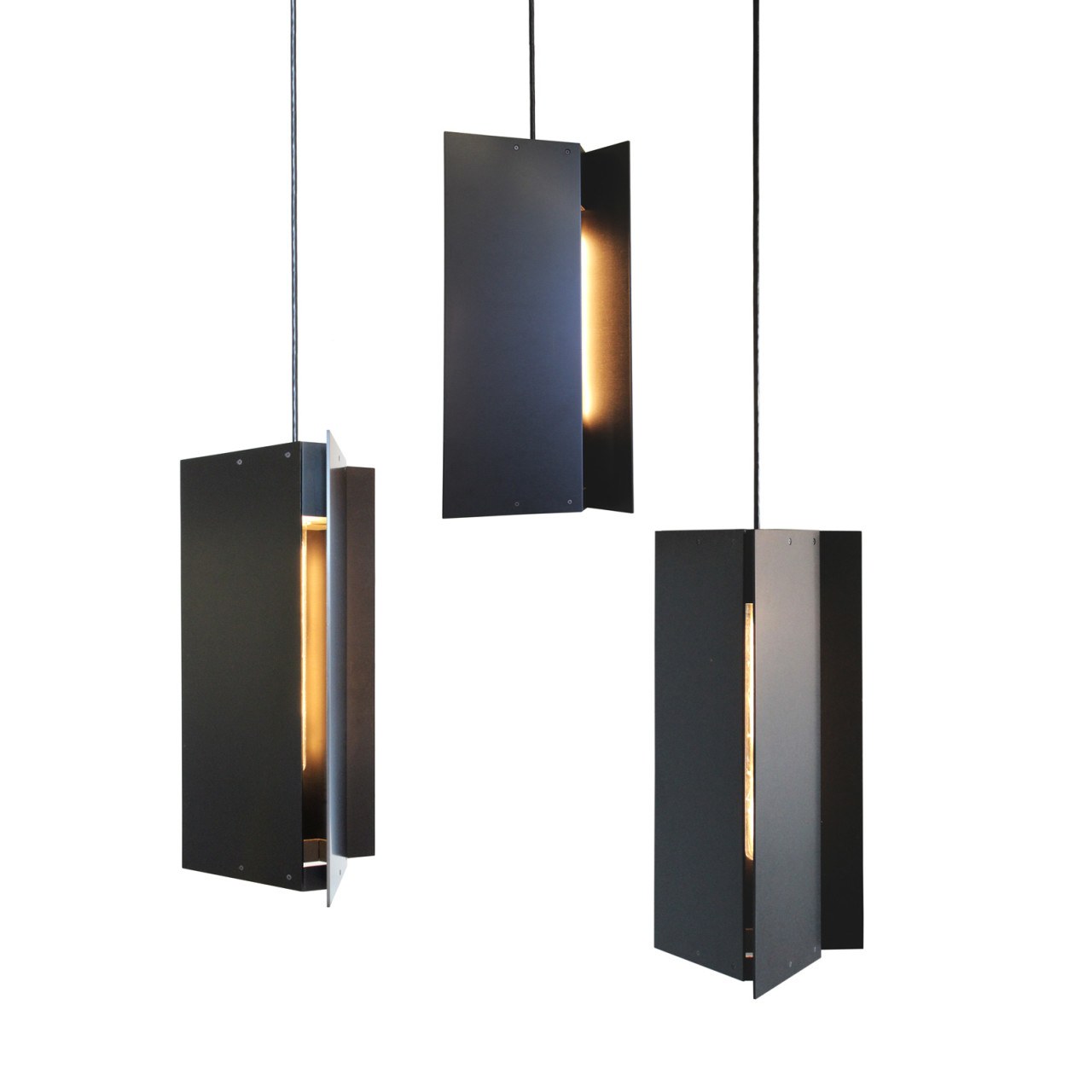 A trio of Pelle’s Tripp Pendants in anodized black aluminum.