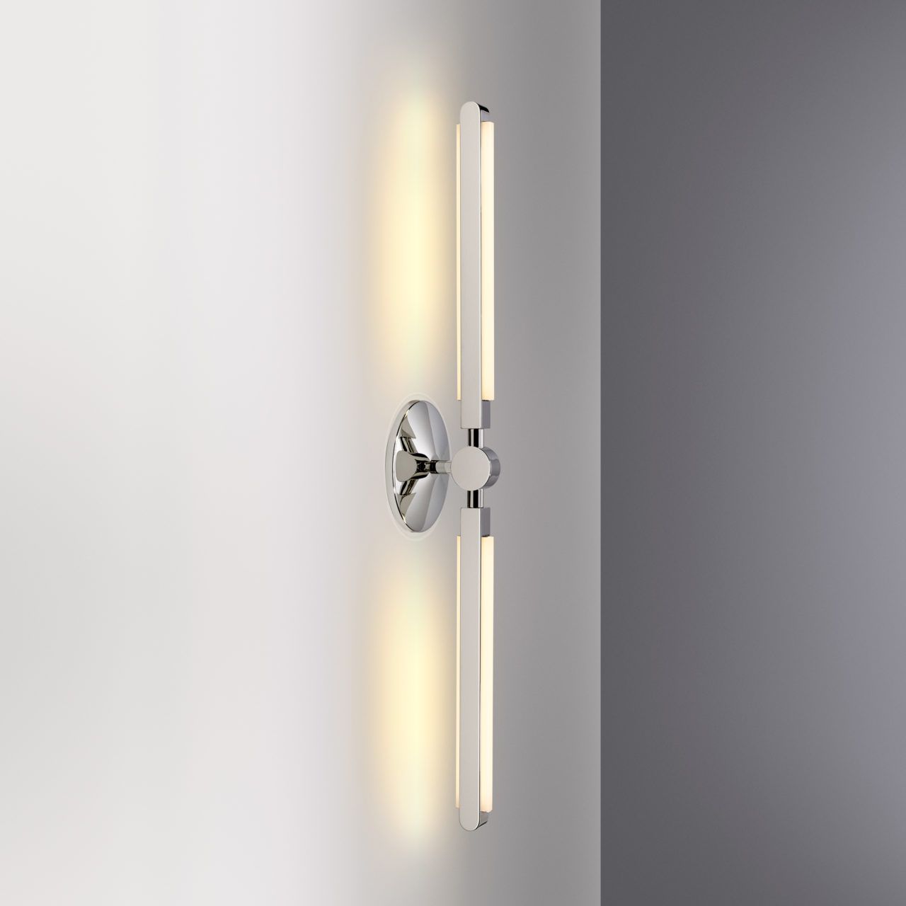 Three quarter view of an illuminated Pris Linear sconce with reflective polished nickel metal components.