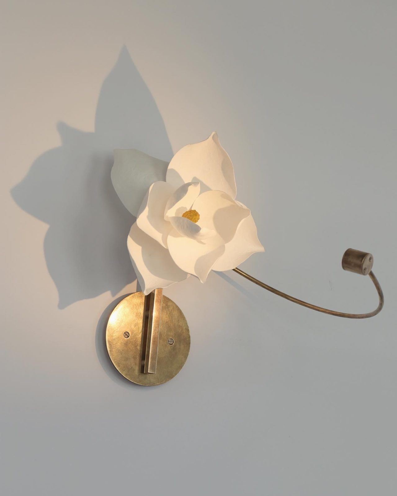 Pelle’s Lure Sconce, with white magnolia flower handmade by the studio.
