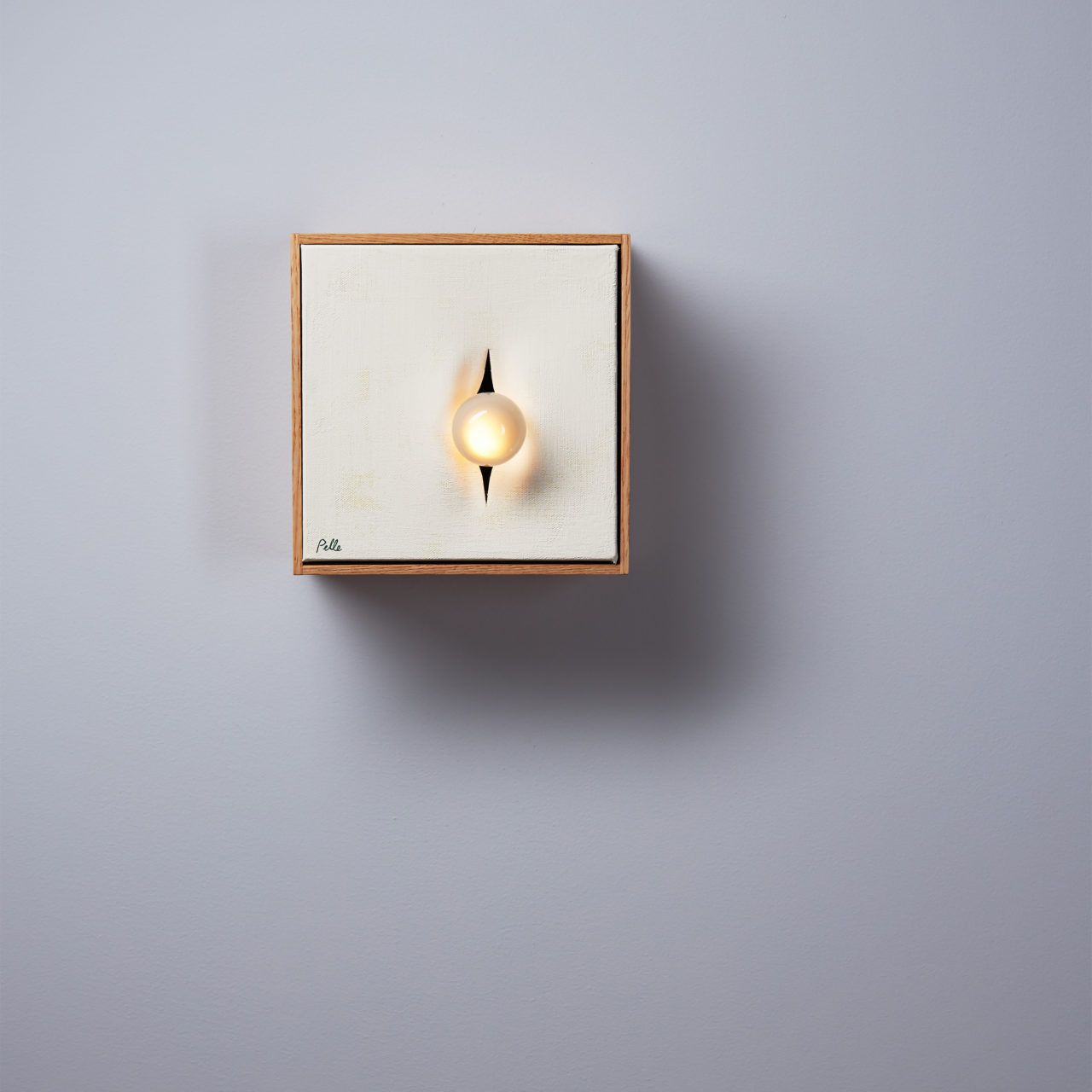 Pelle’s Incise 8x8 wall light, with one bulb set in ivory canvas.