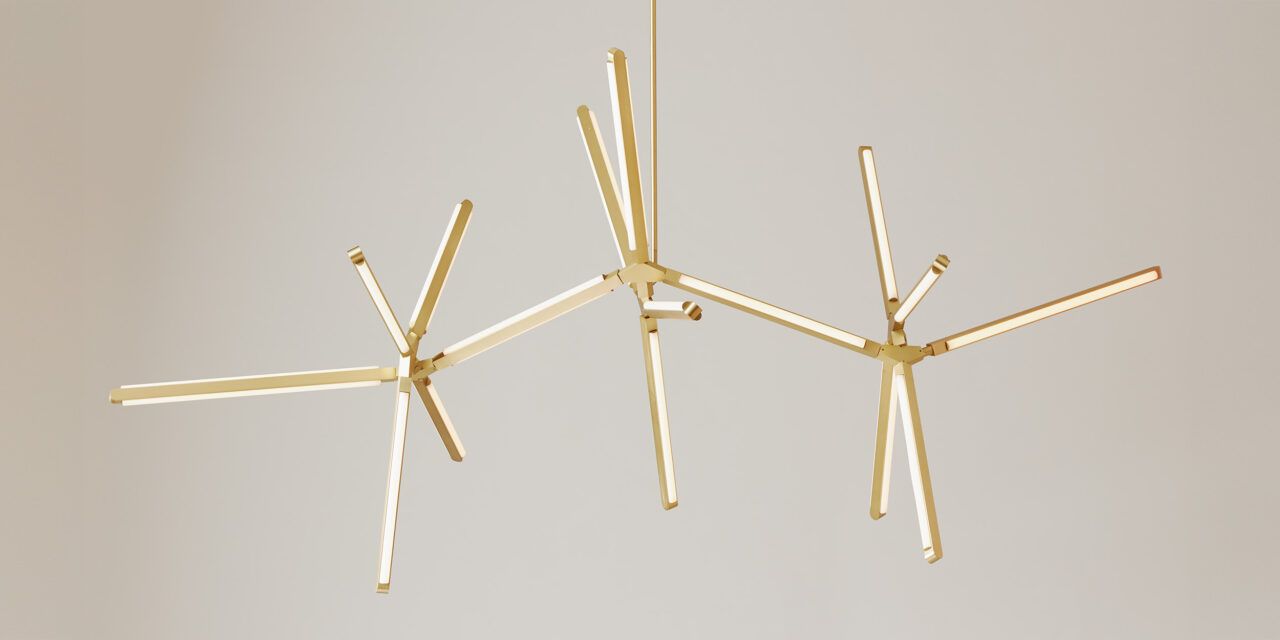Front view of an illuminated Pris Horizon fixture with satin brass metal components