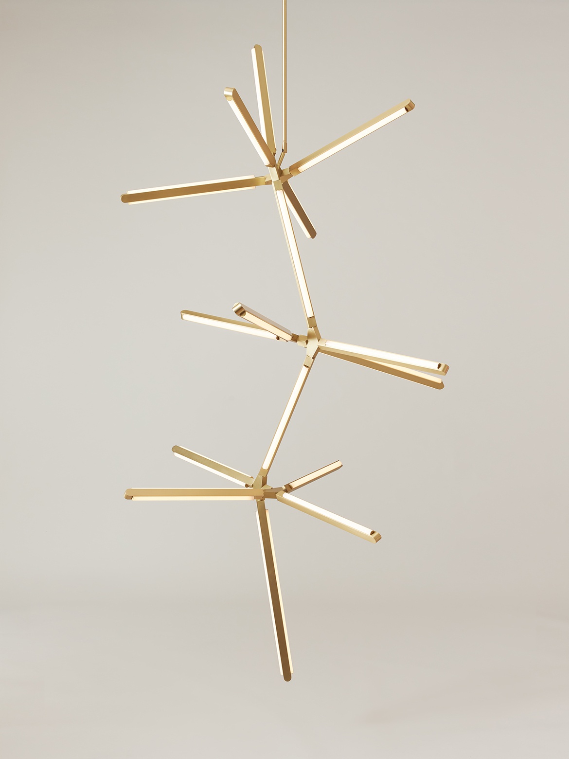 Front view of an illuminated Pris Crystalline 90 fixture with satin brass metal components.