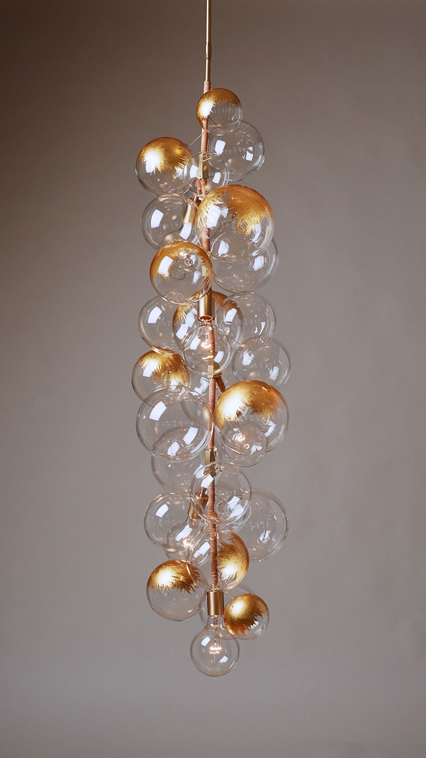 Bubble chandelier with satin brass hardware, natural leather detailing and a feathery 24k gilded finish on its glass globes.