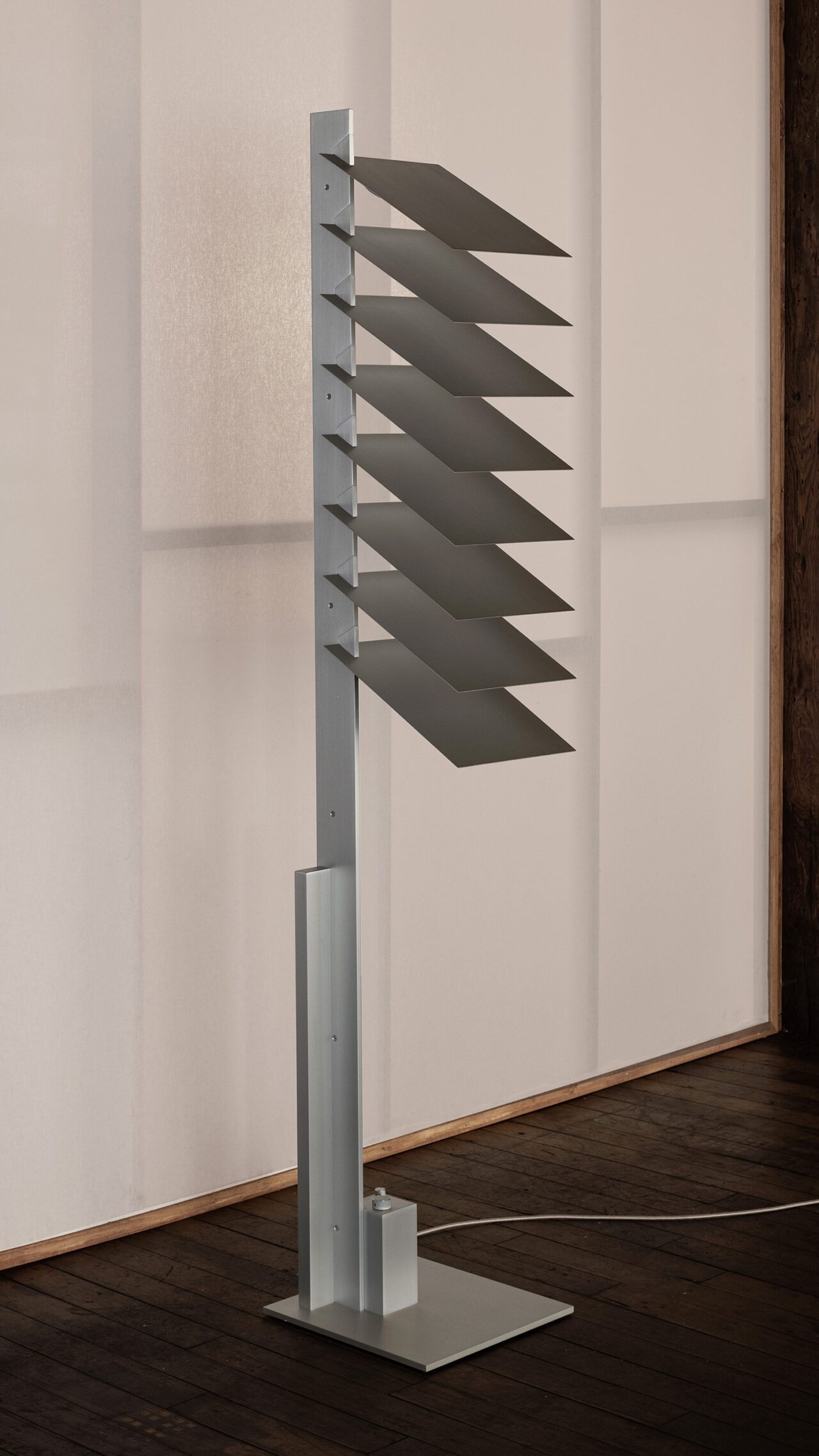 Three quarter view of Pelle’s Be Patient floor lamp, made of hand-finished aluminum louvers.