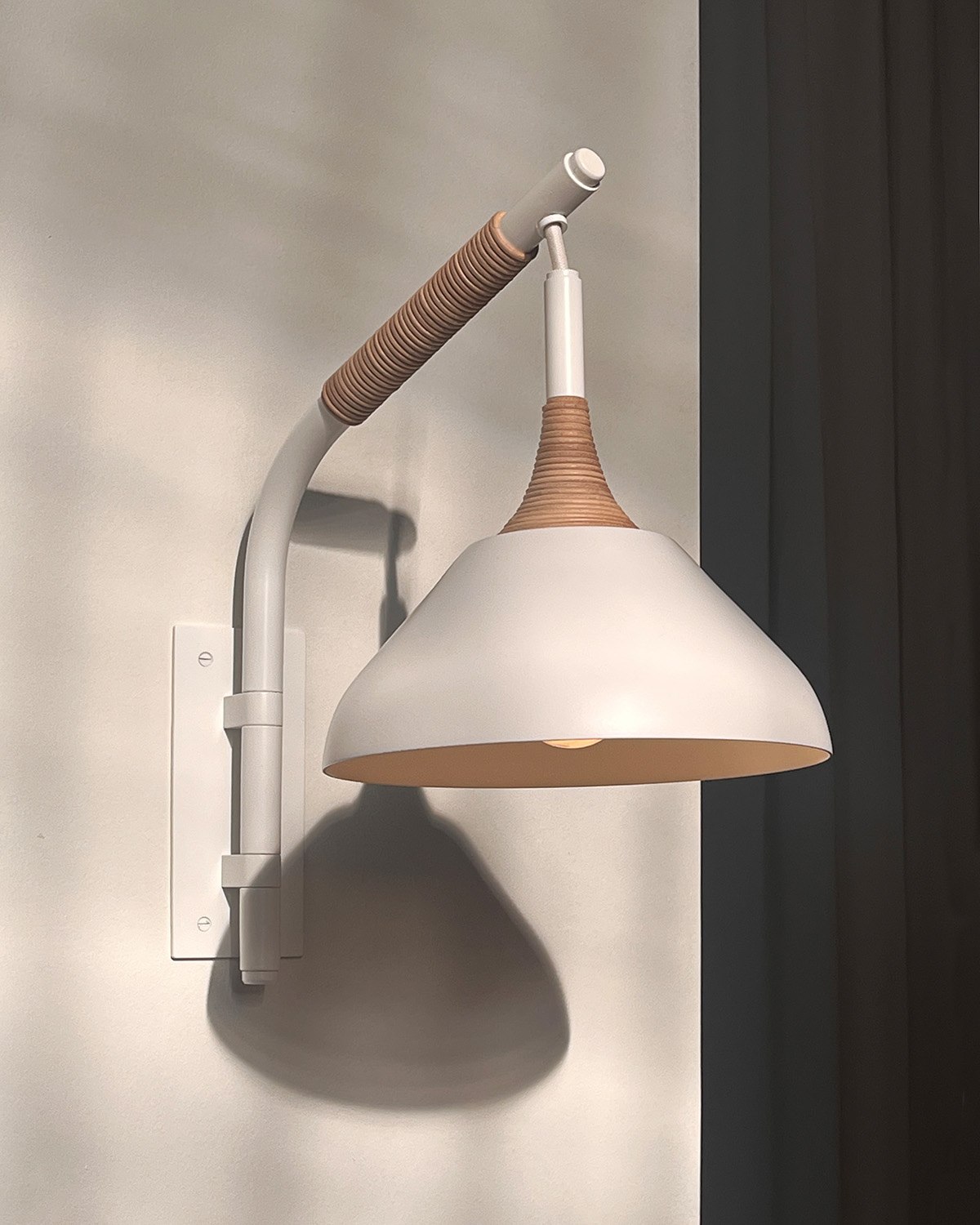 Pelle’s Stem Shade Mini Pivot Sconce in white powder coat with natural leather coiling.