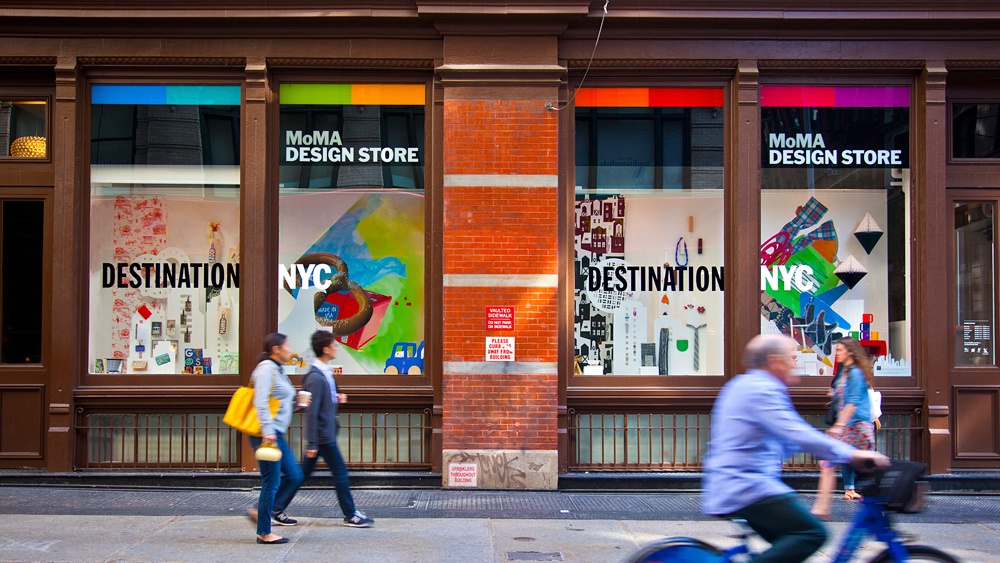 Street view of the MoMA Design Store in Soho, the windows are branded with Destination: NYC signage.