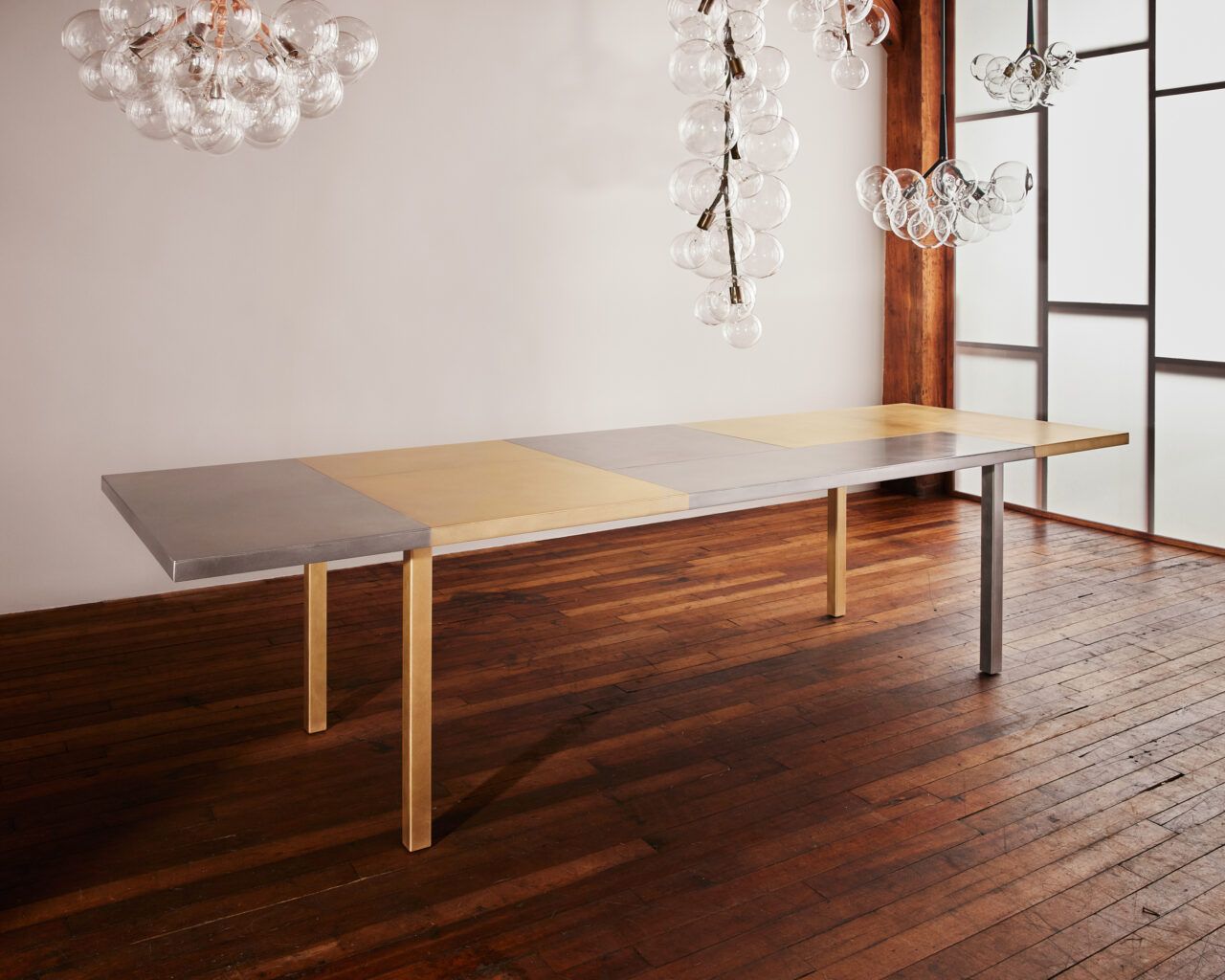 Pelle’s Electrum Dining Table, made of solid stainless steel and brass.